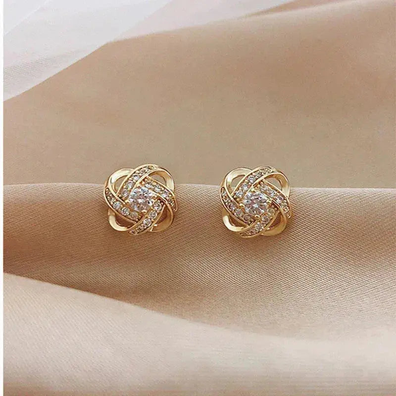 Vanmeeren™ | Gouden spiralen oorbellen met kristallen